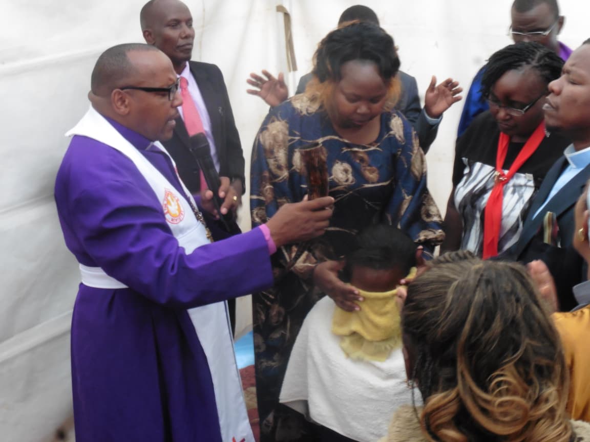Bishop David Kibali praying during an ordination